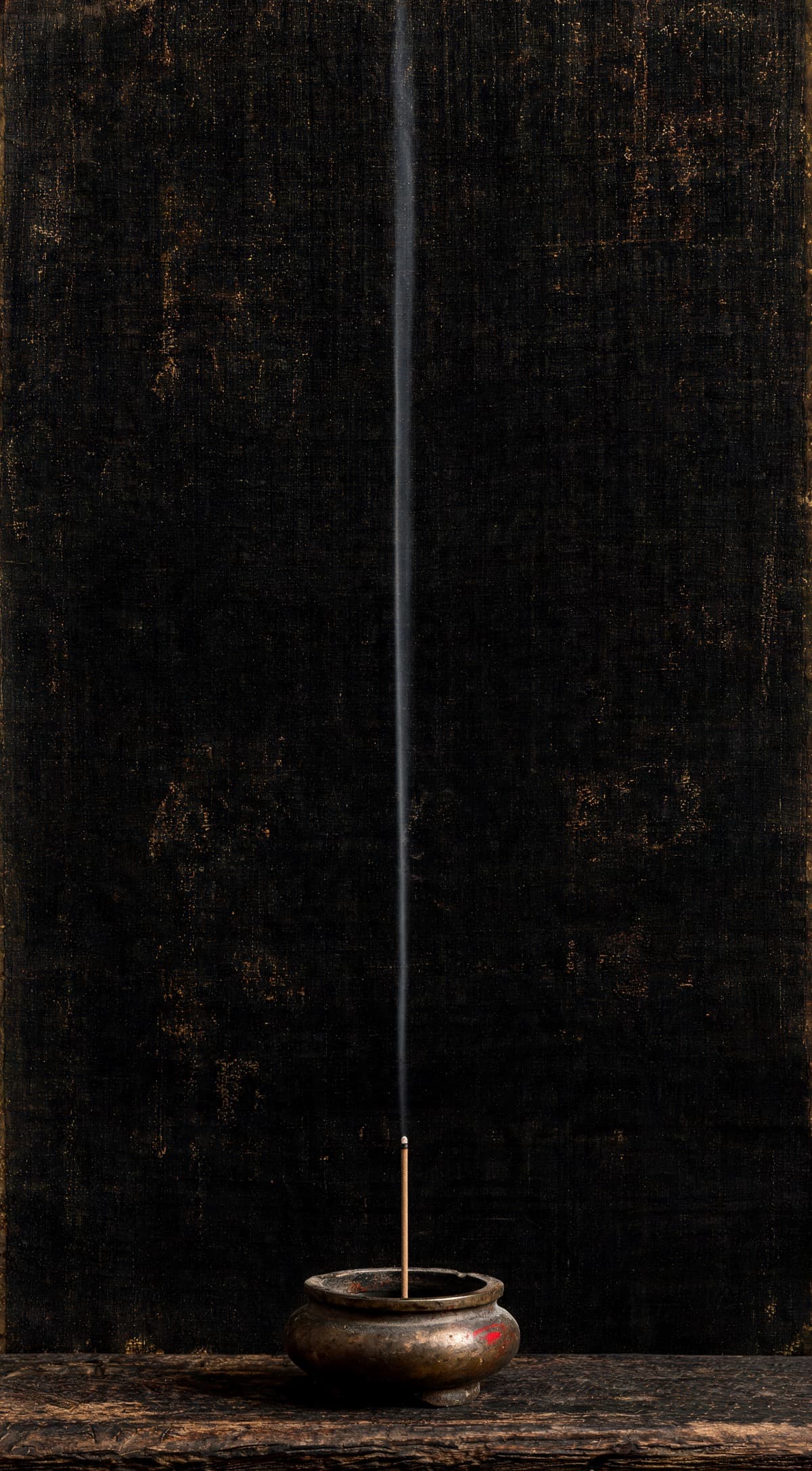 Painting of a single thread of incense smoke rising through still black air from a burner on dark wood