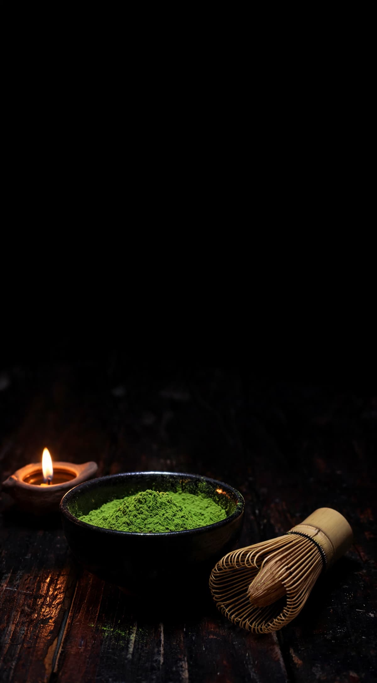 Matcha — The stone-ground leaf, lit by a single flame in a dark kitchen