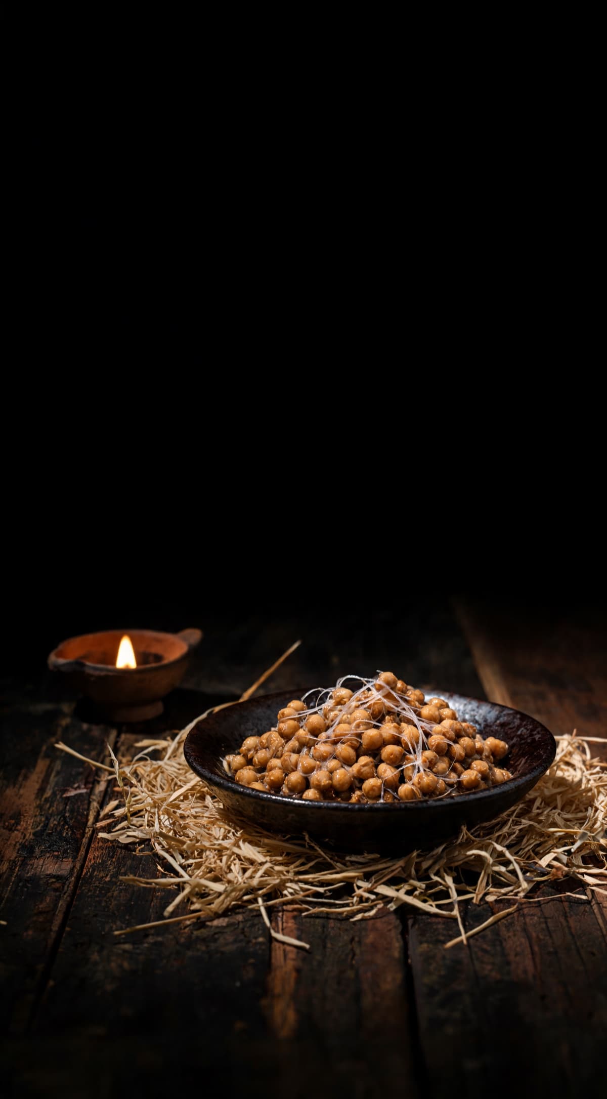 Natto — The fermented soybean, lit by a single flame in a dark kitchen