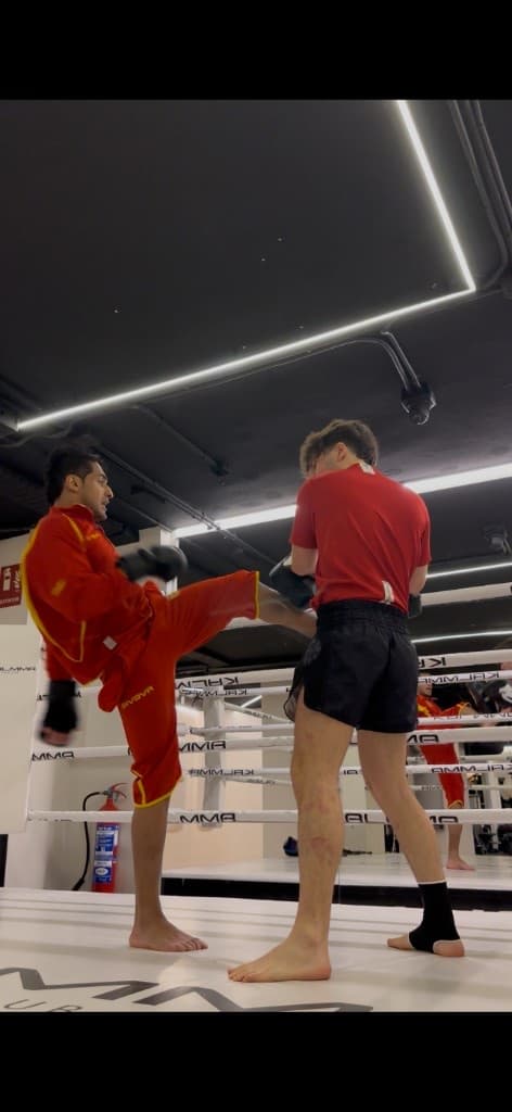 Gaurav Nandipura throwing a high roundhouse kick during MMA sparring