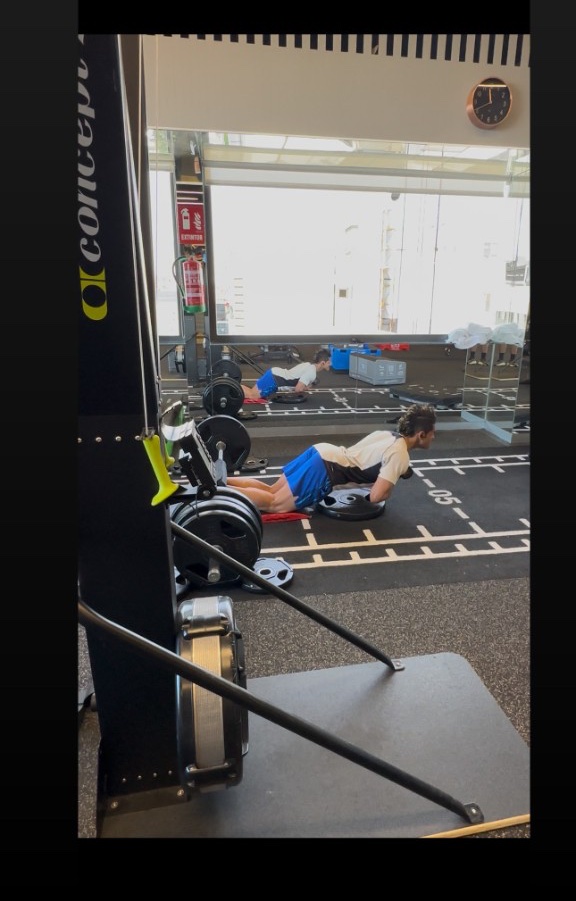 Gaurav Nandipura performing a weighted nordic hamstring curl